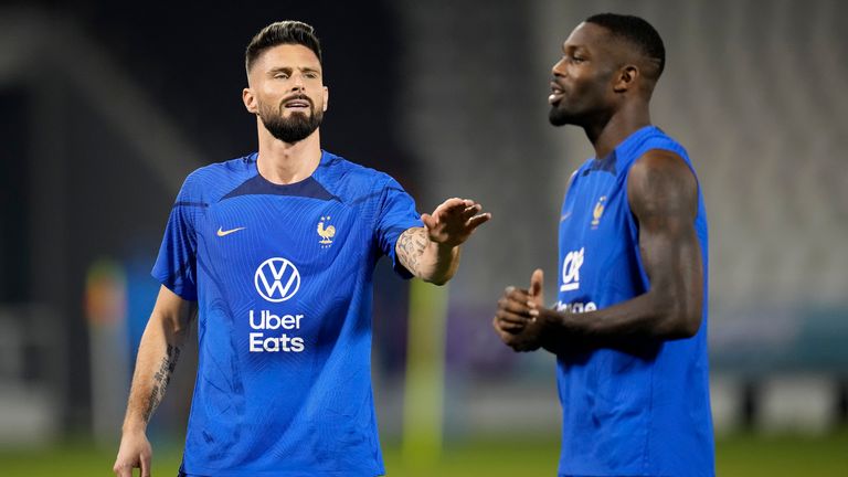 France's Olivier Giroud, left, speaks with Marcus Thuram