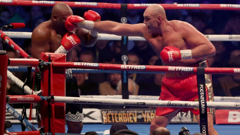 Tyson Fury, right, lands a punch during his WBC heavyweight championship boxing match against Derek Chisora at Tottenham Hotspur&#39;s White Hart Lane stadium London, Saturday Dec. 3, 2022.(AP Photo/Ian Walton)