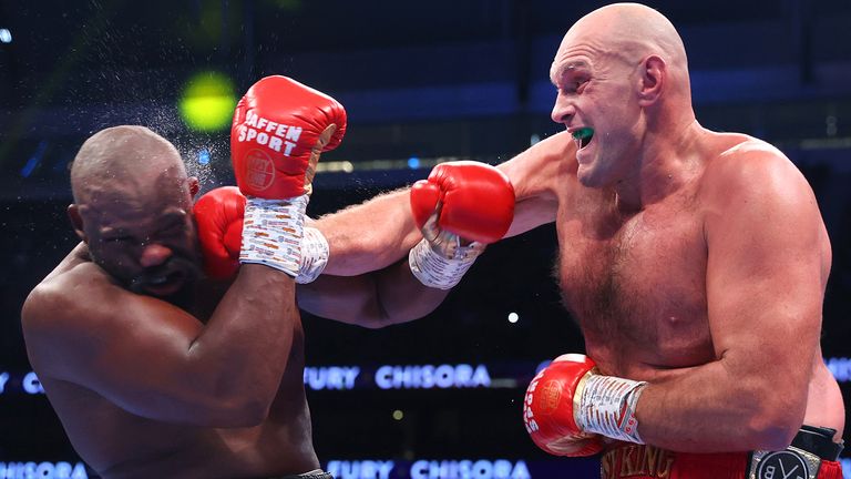 LONDON, ENGLAND - DECEMBER 03: Derek Chisora (L) and Tyson Fury (R) substitute punches someday of their WBC heavyweight championship fight, at Tottenham Hotspur Stadium on December 03, 2022 in London, England. (Photo by Mikey Williams/High Despicable Inc via Getty Photography)