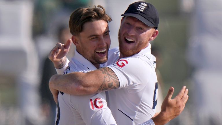 England's Will Jacks, left, celebrates with Ben Stokes after taking the wicket of Pakistan's Abdullah Shafique during the third day of the first test cricket match between Pakistan and England, in Rawalpindi, Pakistan, Saturday, Dec. 3, 2022. (AP Photo/Anjum Naveed)