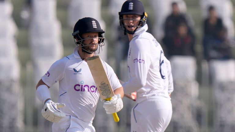 England's Ben Duckett, left, and Zak Crawley run between the wickets during the first day of the first cricket test match between Pakistan and England, in Rawalpindi, Pakistan, Dec. 1, 2022. (AP Photo/Anjum Naveed)