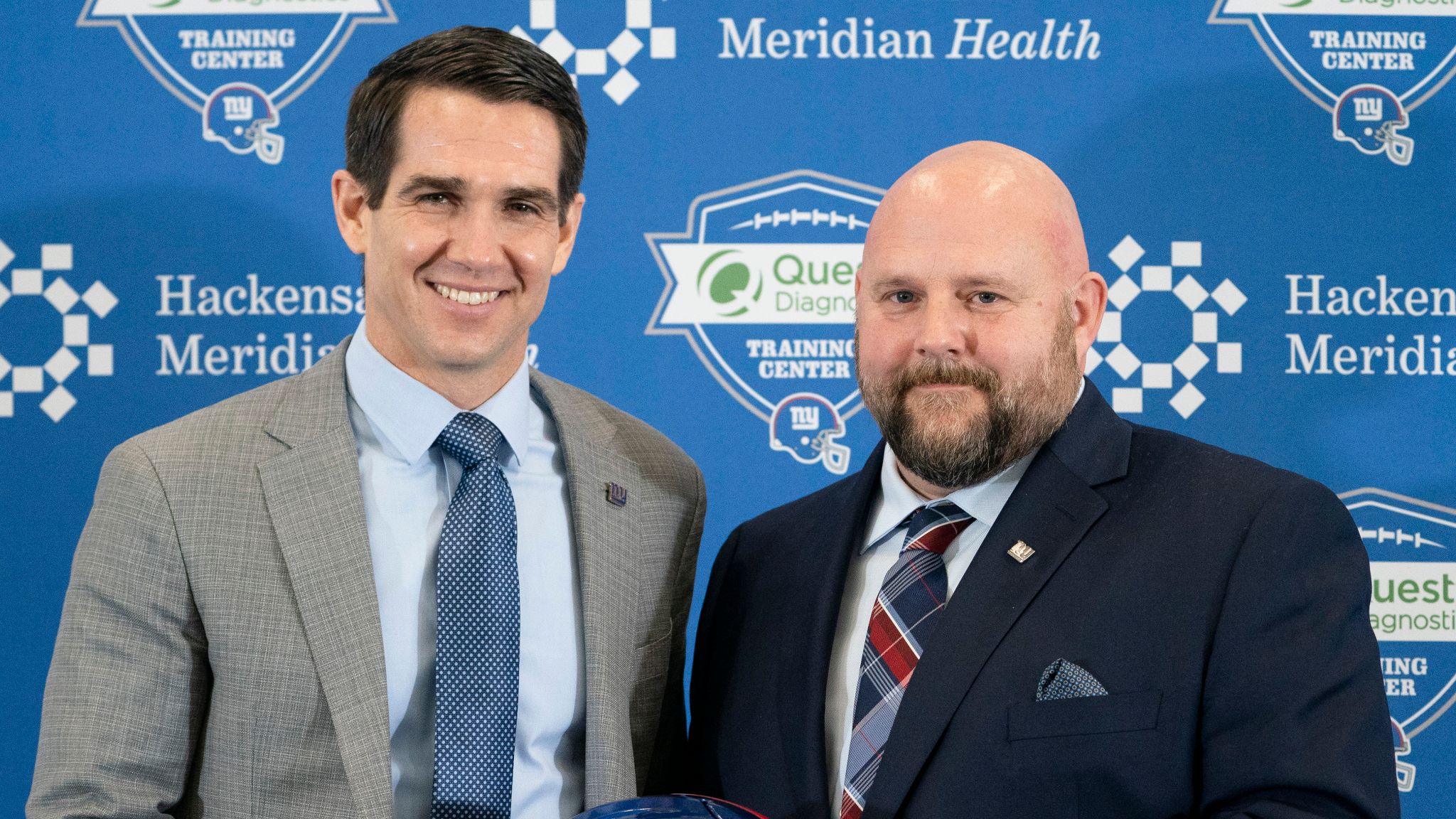 FILE - New York Giants general manager Joe Schoen, left, and Giants new  head coach Brian Daboll, right, pose for a photograph during a news  conference at the NFL football team's training