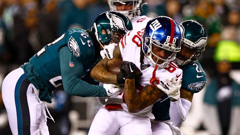 Philadelphia Eagles wide receiver DeVonta Smith (6) is tackled in the end zone by New York Giants safety Julian Love (20) after scoring a touchdown during the first half of an NFL divisional round playoff football game, Saturday, Jan. 21, 2023, in Philadelphia. The Eagles defeated the Giants 38-7.(AP Photo/Rich Schultz)