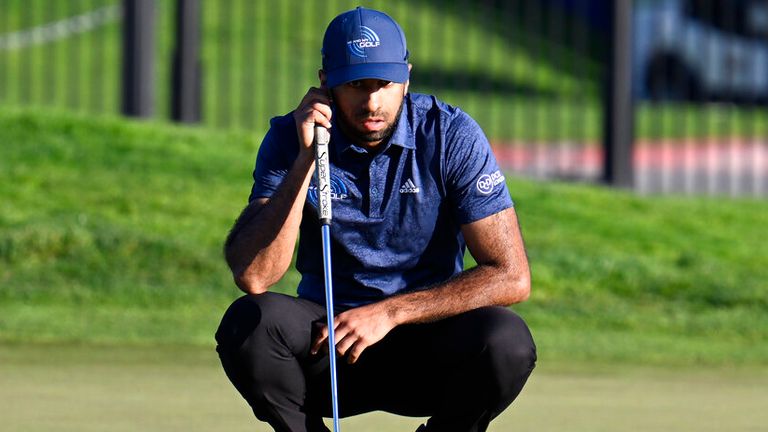 Aaron Rai, of England, lines up a putt on 18th hole of the North Course at Torrey Pines during the first round of the Farmers Insurance Open golf tournament Wednesday, Jan. 25, 2023, in San Diego. (AP Photo/Denis Poroy)
