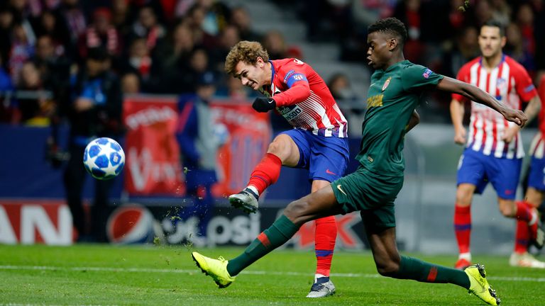 Monaco&#39;s Benoit Badiashile, right, tries to block a shot from Atletico Madrid&#39;s Antoine Griezmann during a Group A Champions League soccer match between Atletico Madrid and Monaco at the Metropolitano stadium in Madrid, Wednesday, Nov. 28, 2018. 