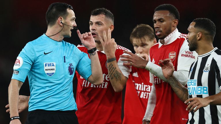 Arsenal players appeal to referee Andy Madley 