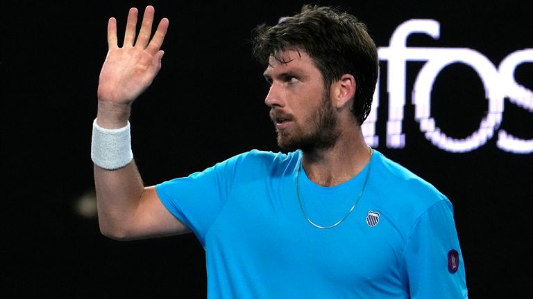 Cameron Norrie of Britain waves after defeating Luca Van Assche of France in their first round match at the Australian Open tennis championship in Melbourne, Australia, Monday, Jan. 16, 2023. (AP Photo/Ng Han Guan)