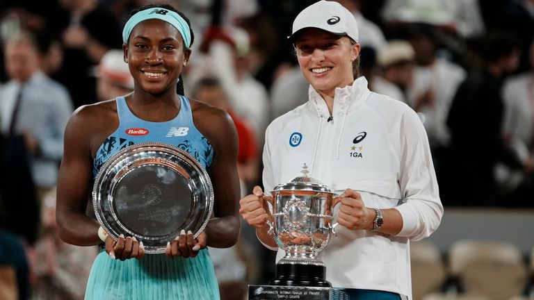 Poland&#39;s Iga Swiatek, right, holds the trophy after winning the final against Coco Gauff, left, in two sets, 6-1, 6-3, at the French Open tennis tournament in Roland Garros stadium in Paris, France, Saturday, June 4, 2022.