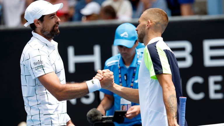 Dan Evans, right, of Britain is congratulated by Jeremy Chardy of France following their second round match at the Australian Open tennis championship in Melbourne, Australia, Thursday, Jan. 19, 2023. (AP Photo/Asanka Brendon Ratnayake)