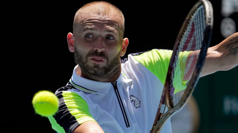Dan Evans of Britain plays a backhand return to Andrey Rublev of Russia during their third round match at the Australian Open tennis championship in Melbourne, Australia, Saturday, Jan. 21, 2023. (AP Photo/Ng Han Guan)