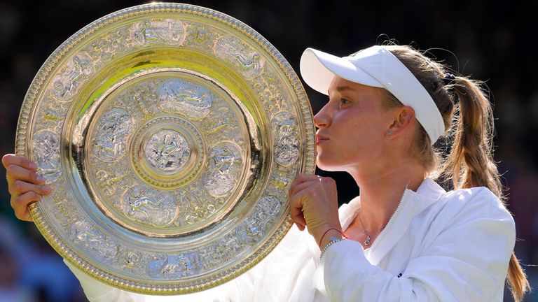 Kazakhstan&#39;s Elena Rybakina kisses the trophy as she celebrates after beating Tunisia&#39;s Ons Jabeur to win the final of the women&#39;s singles on day thirteen of the Wimbledon tennis championships in London, Saturday, July 9, 2022. (AP Photo/Kirsty Wigglesworth)
