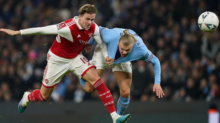 Rob Holding, Arsenal and Manchester City's Erling Haaland battle it out for the ball