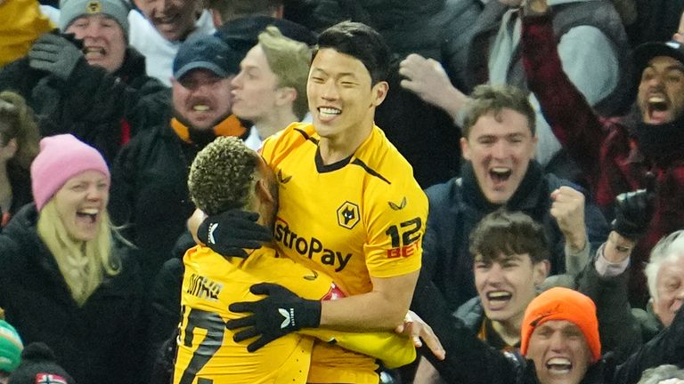 Wolverhampton Wanderers' Hee-Chan Hwang, right, celebrates after scoring his second goal during the English FA Cup soccer match between Liverpool and Wolverhampton Wanderers at Anfield in Liverpool, England, Saturday, Jan. 7.  2023 (AP Photo/Jon Super)