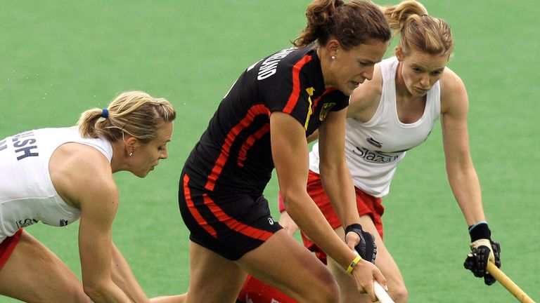England's Kate Walsh left, and team mate Helen Richardson right, try to stop Germany's Janne Muller-Wieland during their women's Champions Trophy hockey match  in Sydney, Australia, Sunday, July 12, 2009. (AP Photo/Rob Griffith)