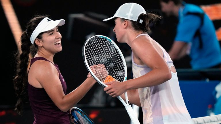 Iga Swiatek, right, of Poland is congratulated by Camila Osorio of Colombia following their second round match at the Australian Open tennis championship in Melbourne, Australia, Wednesday, Jan. 18, 2023. (AP Photo/Dita Alangkara)