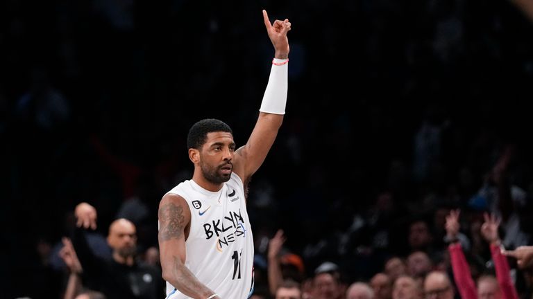 Brooklyn Nets guard Kyrie Irving reats after scoring a three-point basket during the second half of an NBA basketball game against the New York Knicks, Saturday, Jan. 28, 2023, in New York. The Nets won 122-115. 