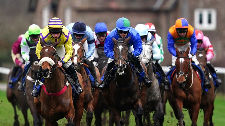 Jet Plane, ridden by jockey Bridget Andrews (blue and green), on their way to winning at Ludlow