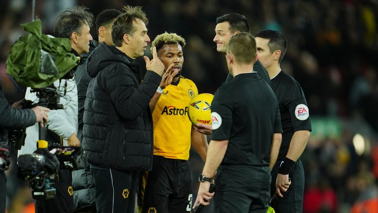 Wolverhampton Wanderers coach Julen Lopetegui, centre, speaks to referee Andy Madley after the English FA Cup soccer match between Liverpool and Wolverhampton Wanderers at Anfield in Liverpool, England Saturday, Jan. 7, 2023 (AP Photo/Jon Super)
