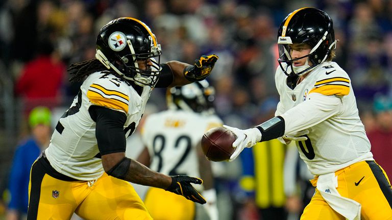 Pittsburgh Steelers quarterback Kenny Pickett (8) hands off to running back Najee Harris (22) in the first half of an NFL football game against the Baltimore Ravens in Baltimore, Sunday, Jan. 1, 2023. (AP Photo/Julio Cortez)