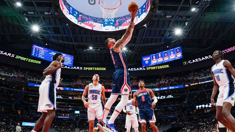 Washington Wizards forward Kyle Kuzma (33) scores against the Orlando Magic during the first half of an NBA basketball game.