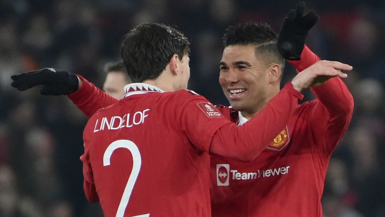 Manchester United's Casemiro, right, celebrates with teammate Manchester United's Victor Lindelof after scoring the opening goal of the game during the English FA Cup 4th round soccer match between Manchester United and Reading at Old Trafford in Manchester, England, Saturday, Jan. 28, 2023. (AP Photo/Rui Vieira)
