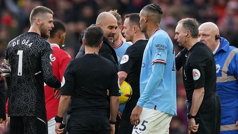 Manchester City manager Pep Guardiola confronts referee Stuart Attwell and the assistant referee at the final whistle following the Premier League match at Old Trafford, Manchester. Picture date: Saturday January 14, 2023.