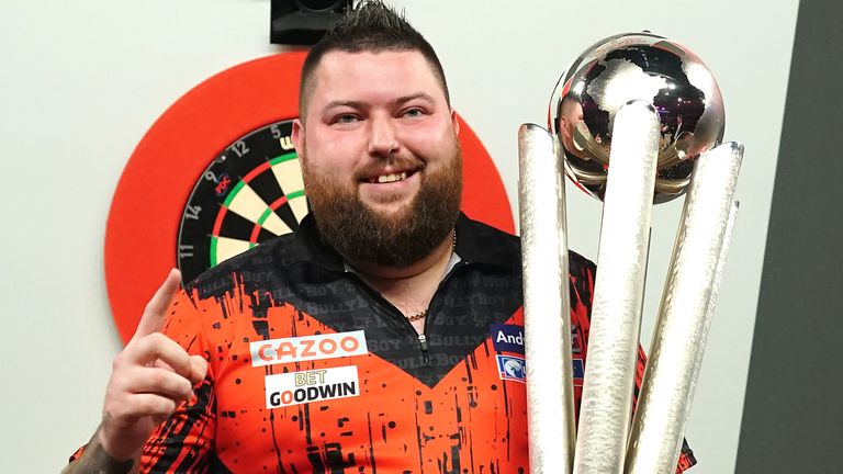 Michael Smith celebrates with the Sid Waddell trophy after winning the final of the Cazoo World Darts Championship against Michael van Gerwen at Alexandra Palace, London. Picture date: Tuesday January 3, 2023.