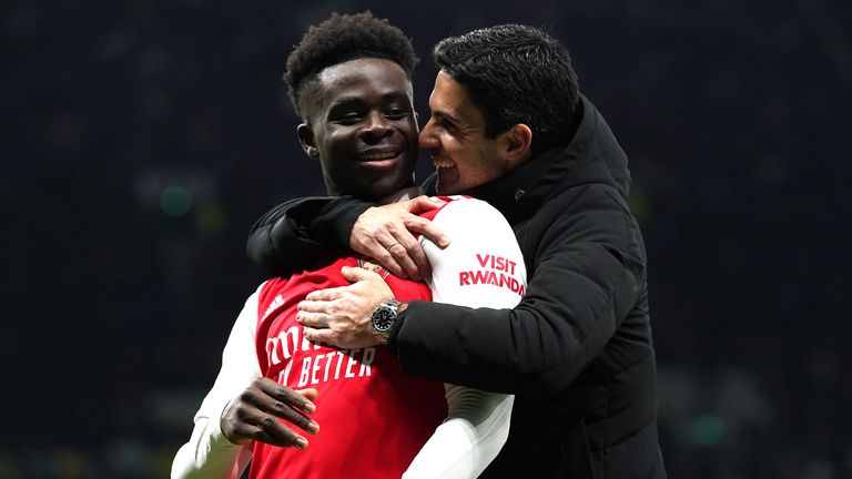 Mikel Arteta embraces Bukayo Saka after the win at Spurs