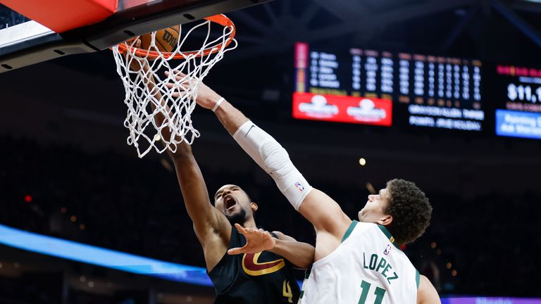 Cleveland Cavaliers forward Evan Mobley (4) shoots against Milwaukee Bucks center Brook Lopez (11) during the second half of an NBA basketball game