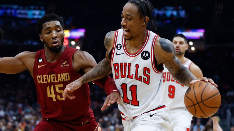 Chicago Bulls forward DeMar DeRozan (11) drives against Cleveland Cavaliers guard Donovan Mitchell (45) during the first half of an NBA basketball game, Monday, Jan. 2, 2023, in Cleveland. 
