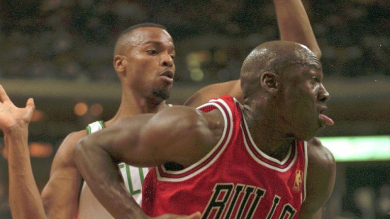 Chicago Bulls Michael Jordan drives past Boston Celtics Todd Day during second quarter action in Boston, Friday, Nov. 1, 1996.