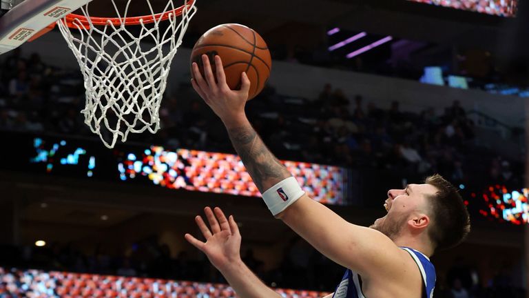 Dallas Mavericks guard Luka Doncic (77) goes up to shoot against the Detroit Pistons in the second half of an NBA game.
