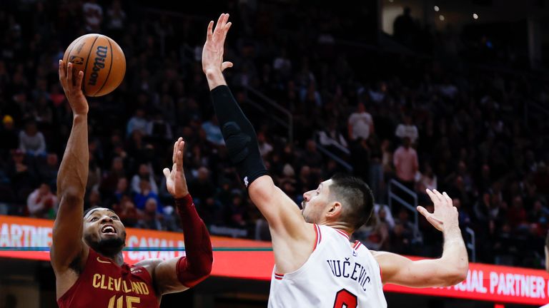 Cleveland Cavaliers guard Donovan Mitchell (45) shoots against Chicago Bulls center Nikola Vucevic (9).