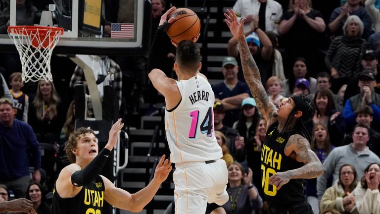 Miami Heat guard Tyler Herro (14) hits the game-winning shot as time expires, while Utah Jazz forward Lauri Markkanen (23) and guard Jordan Clarkson (00) defend during the second half of an NBA basketball game Saturday, Dec. 31, 2022, in Salt Lake City. (AP Photo/George Frey)


