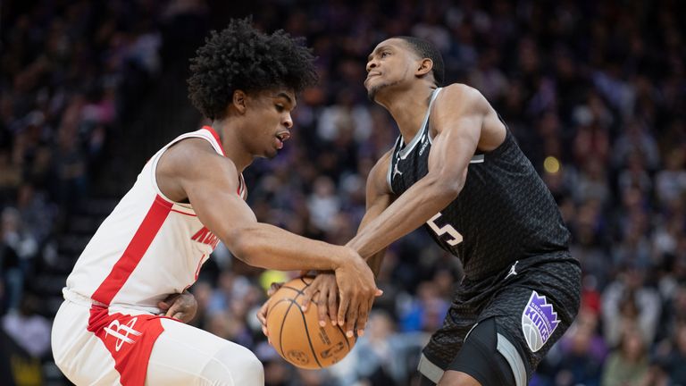 Sacramento Kings guard De&#39;Aaron Fox, right, is fouled by Houston Rockets guard Josh Christopher during the second half of an NBA basketball game in Sacramento, Calif., Friday, Jan. 13, 2023. The Kings won 139-114. 