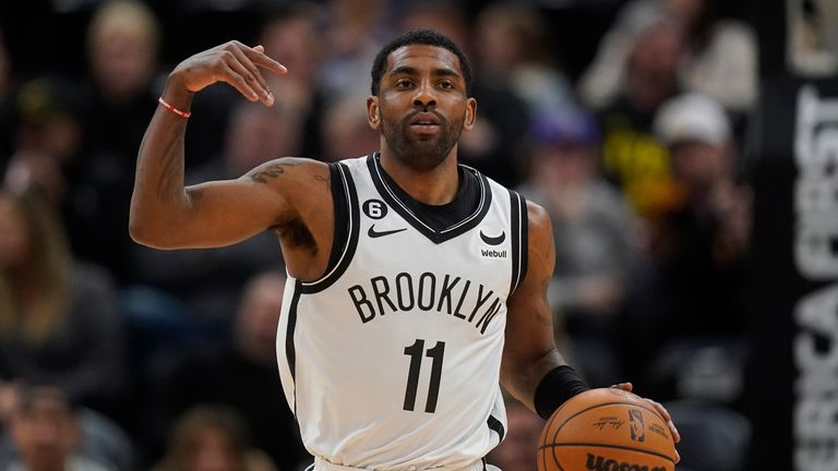 Brooklyn Nets guard Kyrie Irving (11) brings the ball up court during the first half of an NBA basketball game against the Utah Jazz.