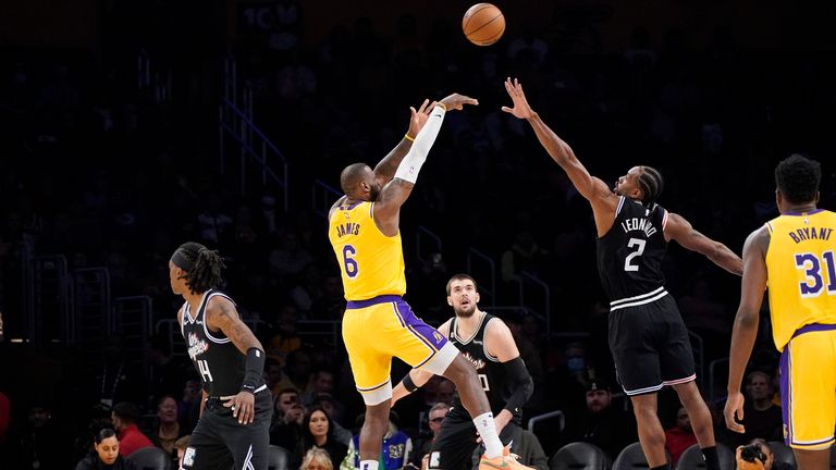 Los Angeles Lakers forward LeBron James (6) shoots as Los Angeles Clippers forward Kawhi Leonard (2) defends and guard Terance Mann (14).