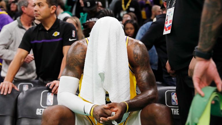 Los Angeles Lakers&#39; LeBron James sits on the bench during overtime in the team&#39;s NBA basketball game against the Boston Celtics.