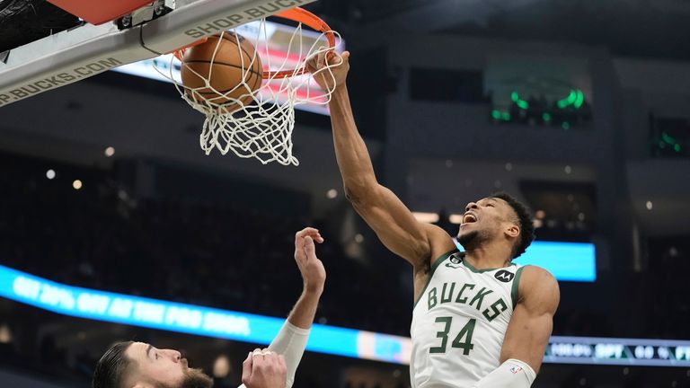 Milwaukee Bucks' Giannis Antetokounmpo dunks over New Orleans Pelicans' Jonas Valanciunas during the first half of an NBA game.
