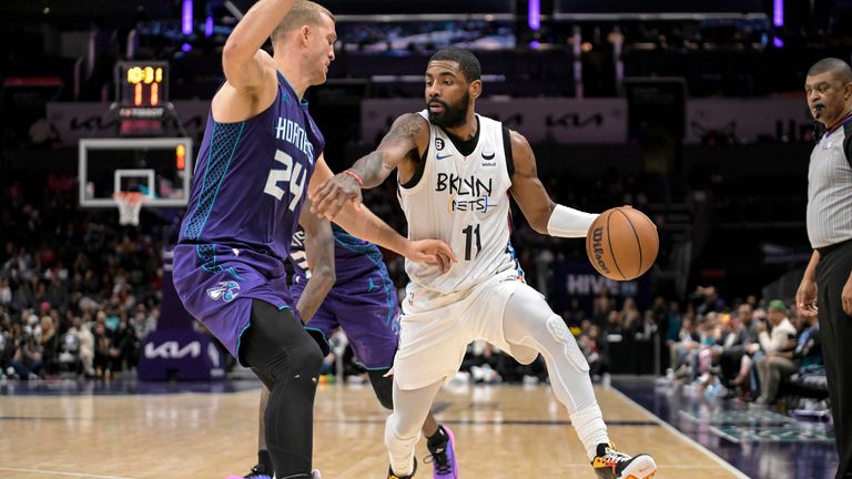 Brooklyn Nets guard Kyrie Irving (11) looks to drive past Charlotte Hornets center Mason Plumlee (24) 1during the second half of an NBA basketball game, Saturday, Dec. 31, 2022, in Charlotte, N.C. (AP Photo/Matt Kelley)


