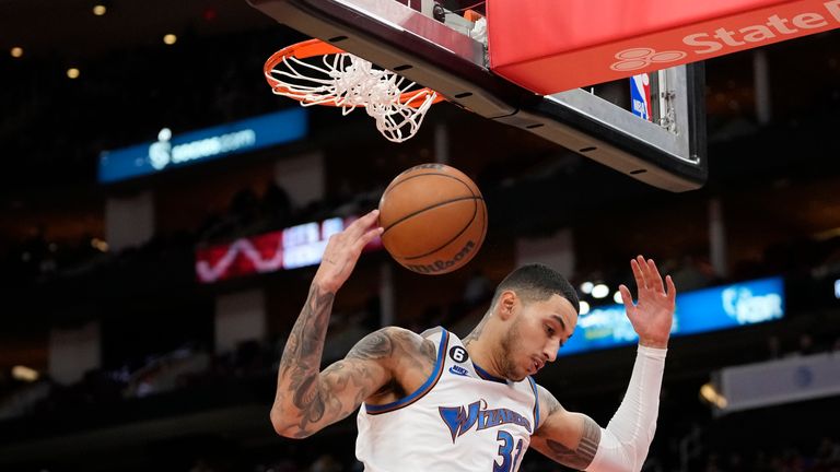 Washington Wizards' Kyle Kuzma dunks the ball during the second half of an NBA basketball game against the Houston Rockets.