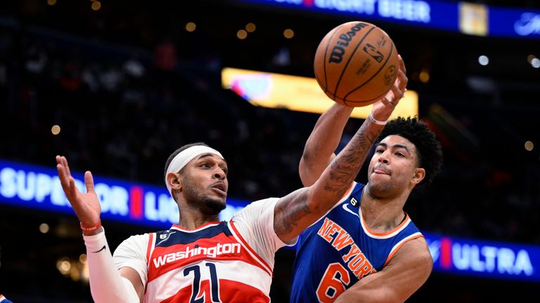 Washington Wizards center Daniel Gafford (21) and New York Knicks guard Quentin Grimes (6) reach for the ball during the first half of an NBA basketball game Friday, Jan. 13, 2023, in Washington.