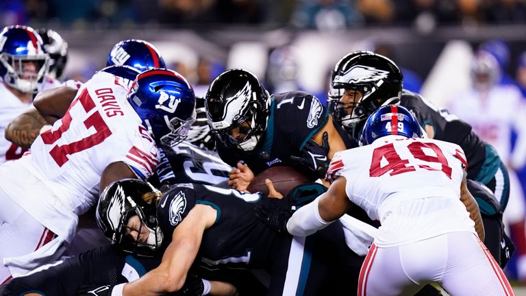 Philadelphia Eagles quarterback Jalen Hurts (1) keeps the ball while gaining yardage for a first down against the New York Giants during the second half of an NFL football game, Sunday, Jan. 8, 2023, in Philadelphia.