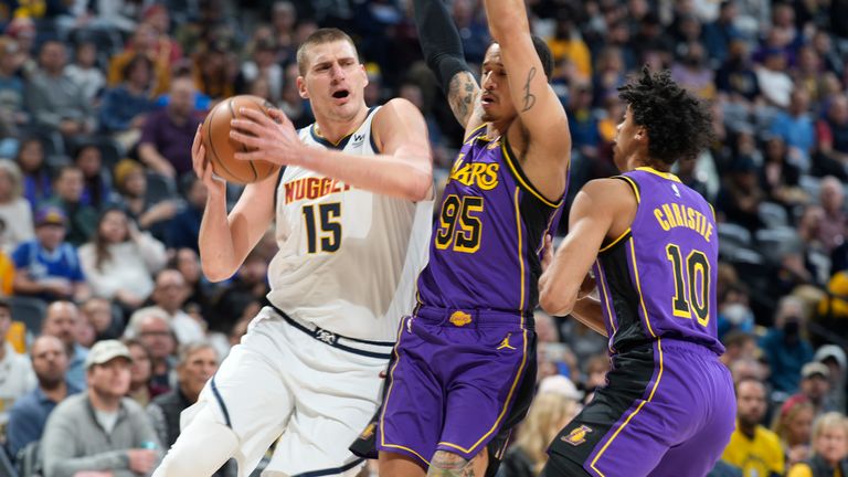 Denver Nuggets center Nikola Jokic drives to the basket as Los Angeles Lakers forward Juan Toscano-Anderson, center, and guard Max Christie defend