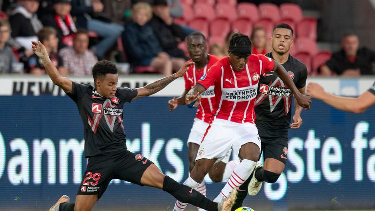PSV Eindhovens Noni Madueke, right, and FC Midtjyllands Paulinho, in action during the Champions League qualifier between FC Midtjylland and PSV Eindhoven at MCH Arena in Herning, Denmark, Tuesday Aug. 10, 2021.(Bo Amstrup/Ritzau Scanpix via AP)