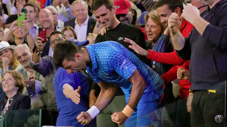 Novak Djokovic of Serbia celebrates with his support team after defeating Stefanos Tsitsipas of Greece in the men&#39;s singles final at the Australian Open tennis championship in Melbourne, Australia, Sunday, Jan. 29, 2023. (AP Photo/Aaron Favila)