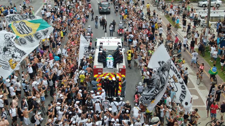 Pele&#39;s coffin travels through the city of Santos on a fire engine