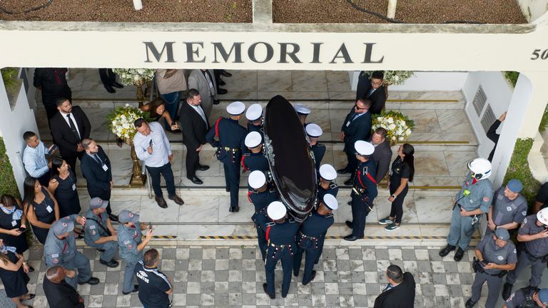 Pele's coffin is carried into Necropole Ecumenica Memorial Cemetery at the end of his funeral procession