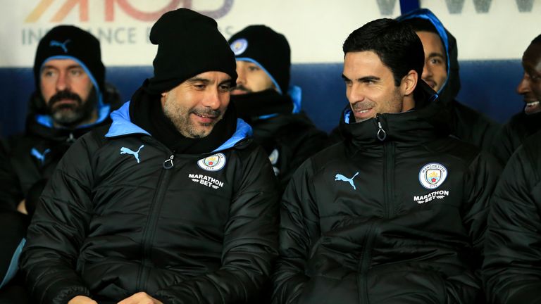 Manchester City's head coach Pep Guardiola and Mikel Arteta converse before the EFL Carabao Cup quarter finals soccer match between Oxford United and Manchester City at the Kassam Stadium, England, in Oxford, England, Wednesday, Dec. 18, 2019.