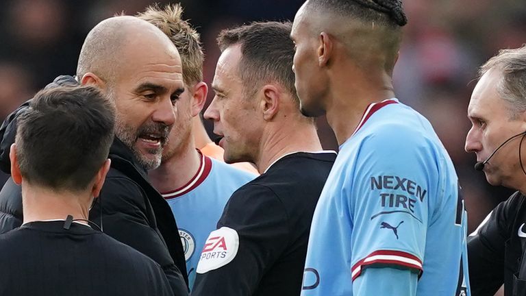 Pep Guardiola confronts referee Stuart Attwell and the assistant referee at full-time